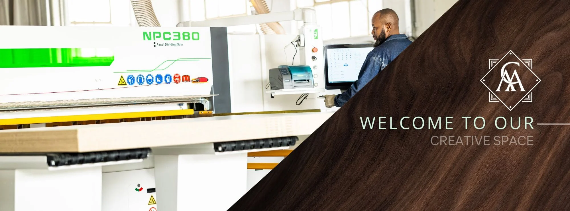 An operator at the controls of the NPC380 CNC panel dividing saw in the Colin Mathews Joinery workshop