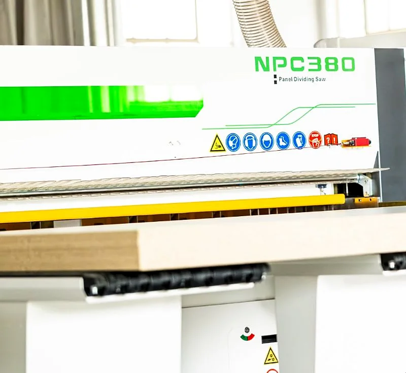 CNC panel saw cutting an oak-veneer board to size