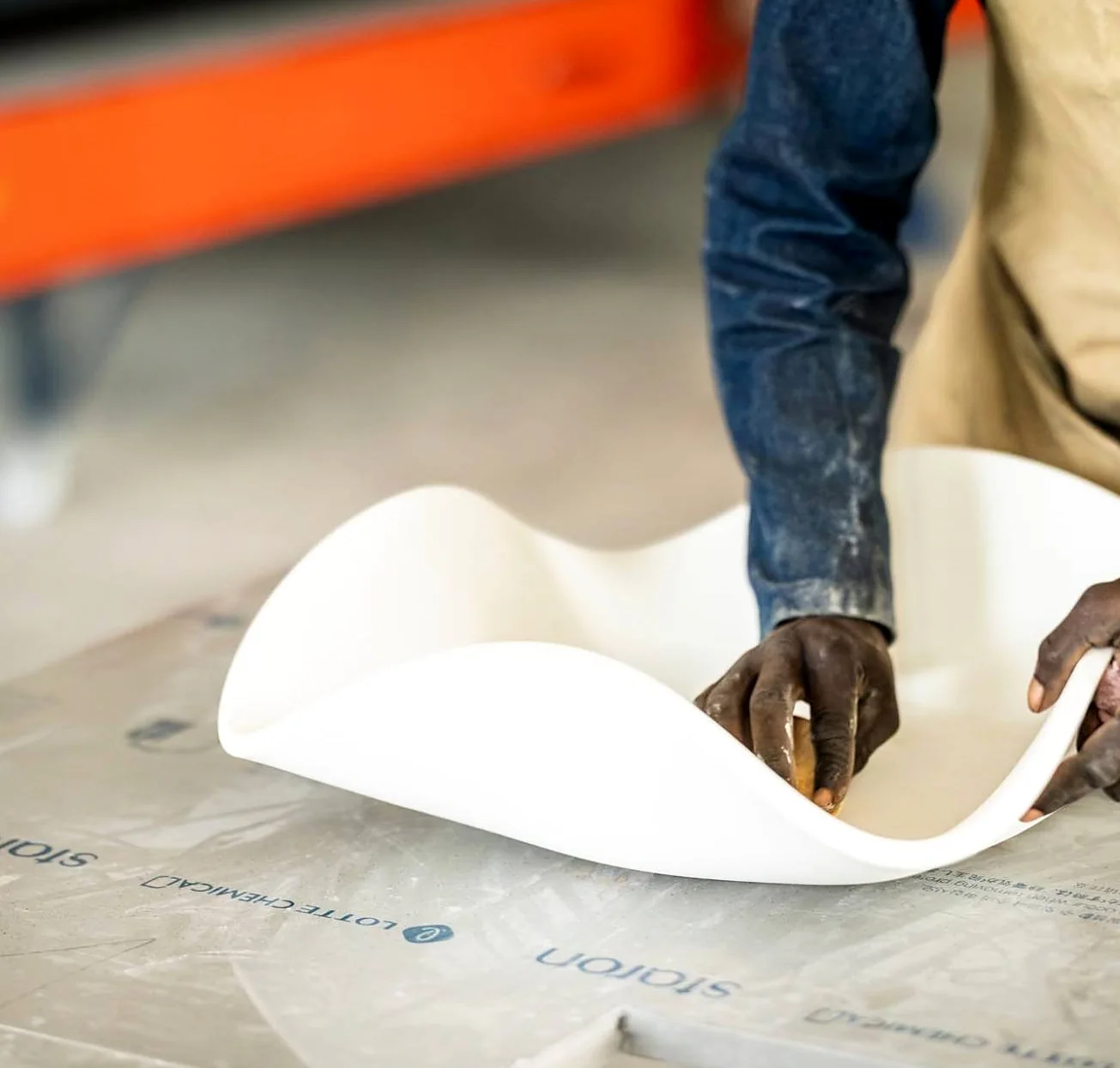Hands shaping a heat-formed Staron solid-surface panel